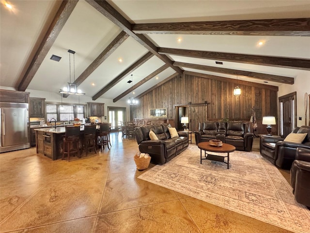 living room featuring a barn door, beamed ceiling, visible vents, and high vaulted ceiling