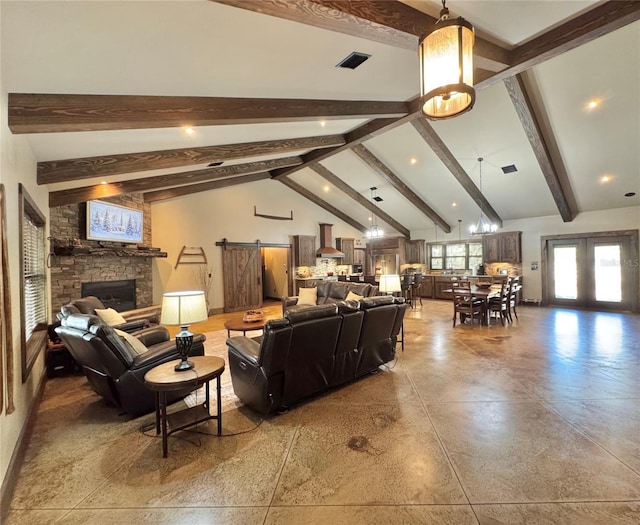 living area featuring visible vents, finished concrete flooring, beam ceiling, a fireplace, and french doors