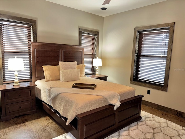 bedroom with a ceiling fan and baseboards