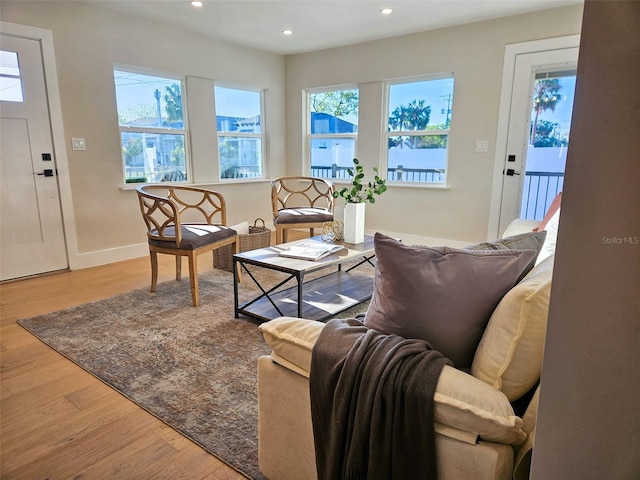 living room with recessed lighting, wood finished floors, and baseboards