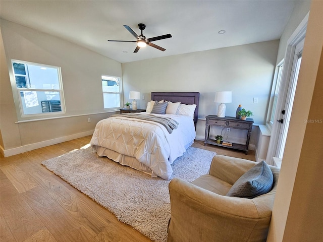 bedroom featuring ceiling fan, baseboards, and wood finished floors