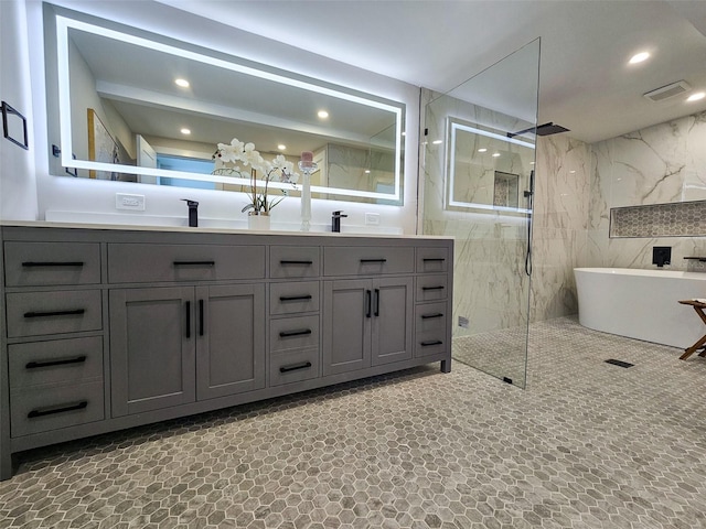 bathroom with double vanity, recessed lighting, visible vents, and a marble finish shower