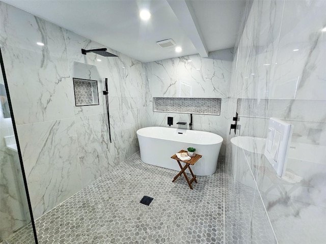 bathroom featuring a marble finish shower, visible vents, recessed lighting, a freestanding tub, and tile walls