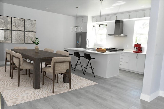 dining space featuring light wood finished floors