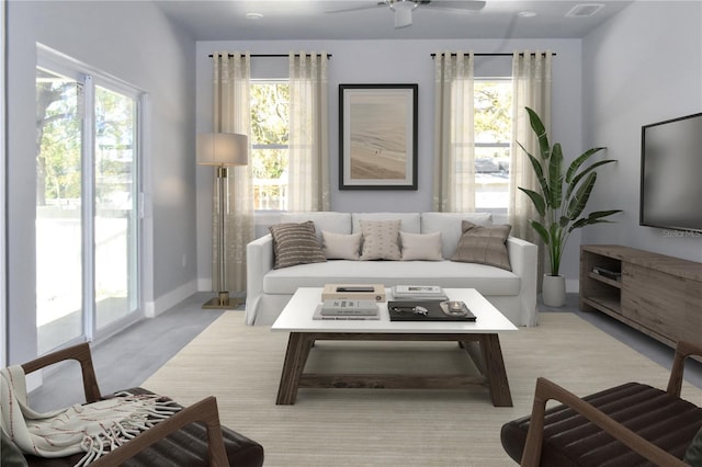 living area featuring ceiling fan and baseboards