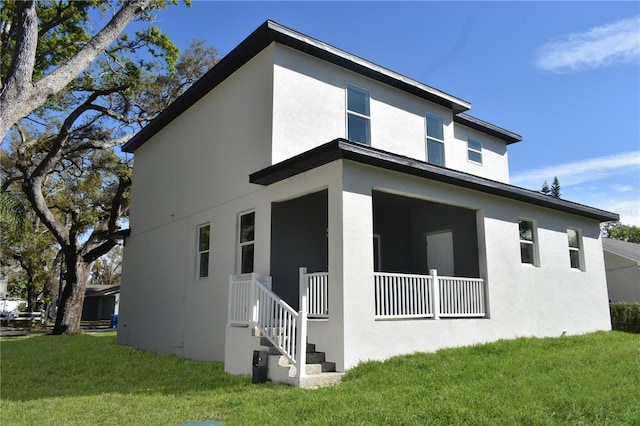 view of property exterior with stucco siding and a lawn