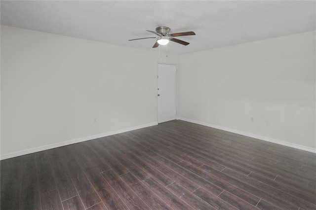 empty room with baseboards, dark wood-type flooring, and ceiling fan