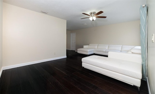 living area with ceiling fan, visible vents, baseboards, and wood finished floors