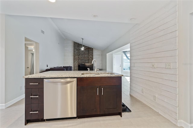 kitchen featuring open floor plan, dark brown cabinets, a sink, and stainless steel dishwasher