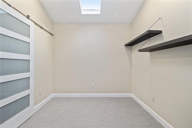 spacious closet featuring a barn door