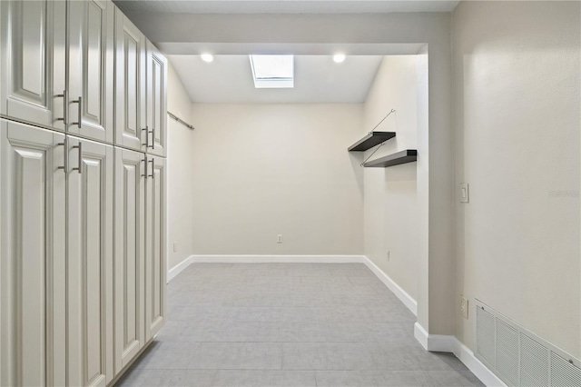 interior space featuring a skylight and visible vents