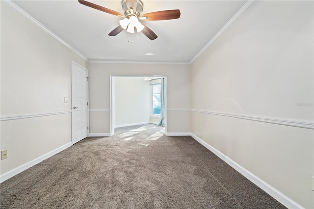 carpeted empty room with crown molding, baseboards, and ceiling fan