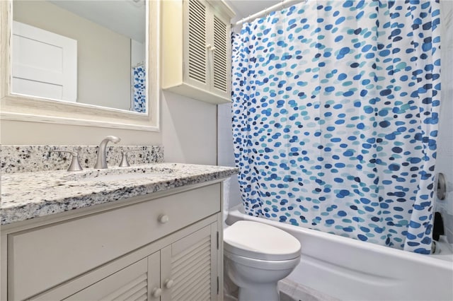 bathroom featuring vanity, shower / tub combo, and toilet