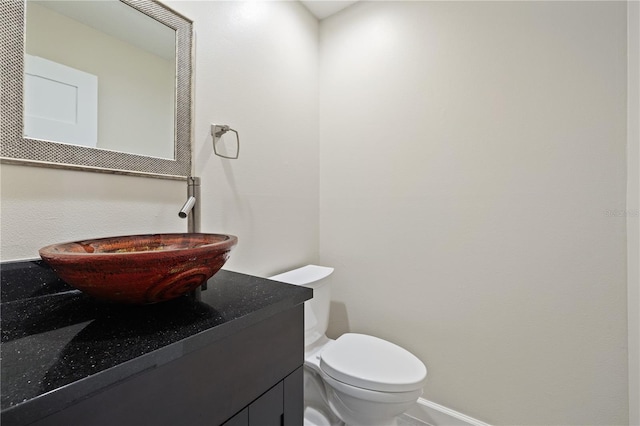 half bath featuring toilet and vanity