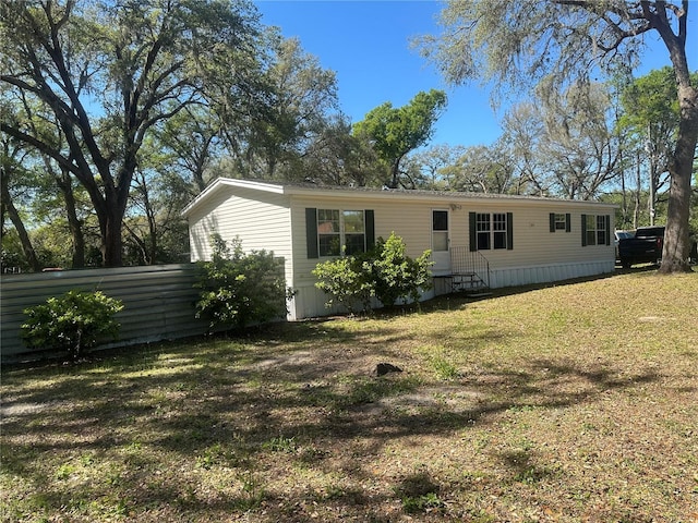 rear view of property with a yard