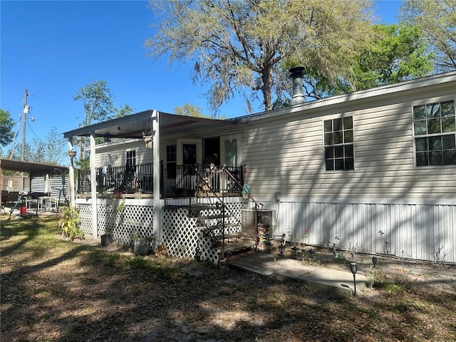 back of house with a wooden deck