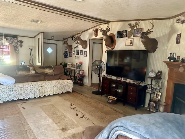 bedroom with visible vents, a fireplace, and a textured ceiling