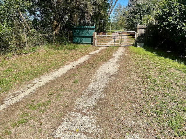 view of street featuring a gated entry and a gate