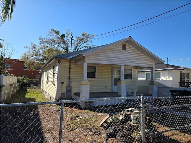 view of front of house with covered porch and a fenced backyard