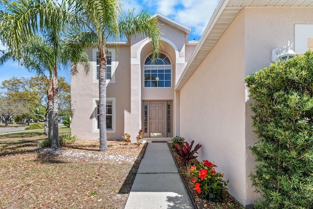 doorway to property featuring stucco siding