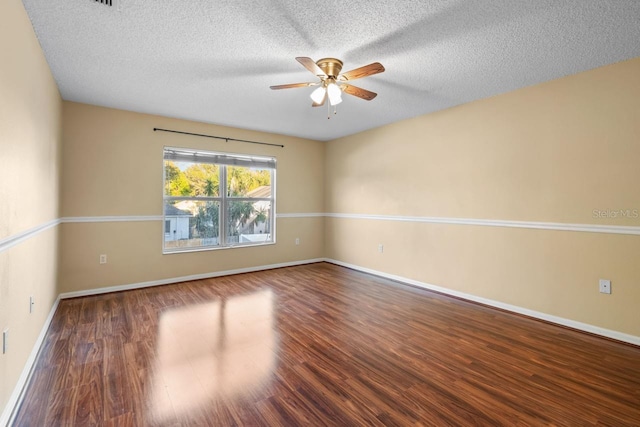 empty room featuring baseboards, a textured ceiling, a ceiling fan, and wood finished floors