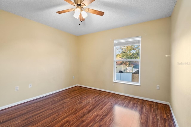 spare room with ceiling fan, a textured ceiling, baseboards, and wood finished floors