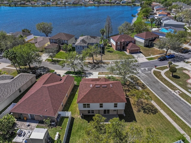 birds eye view of property with a residential view and a water view