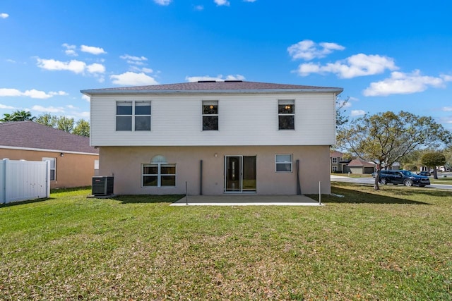 back of house featuring a yard, central AC, stucco siding, and a patio area