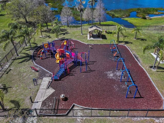 communal playground featuring a gazebo, a lawn, and fence