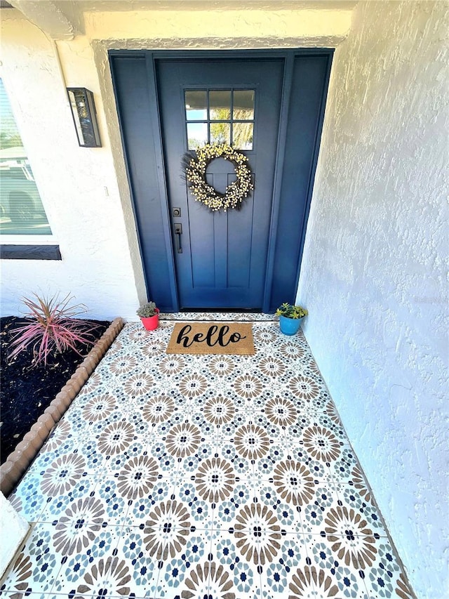 doorway to property with stucco siding