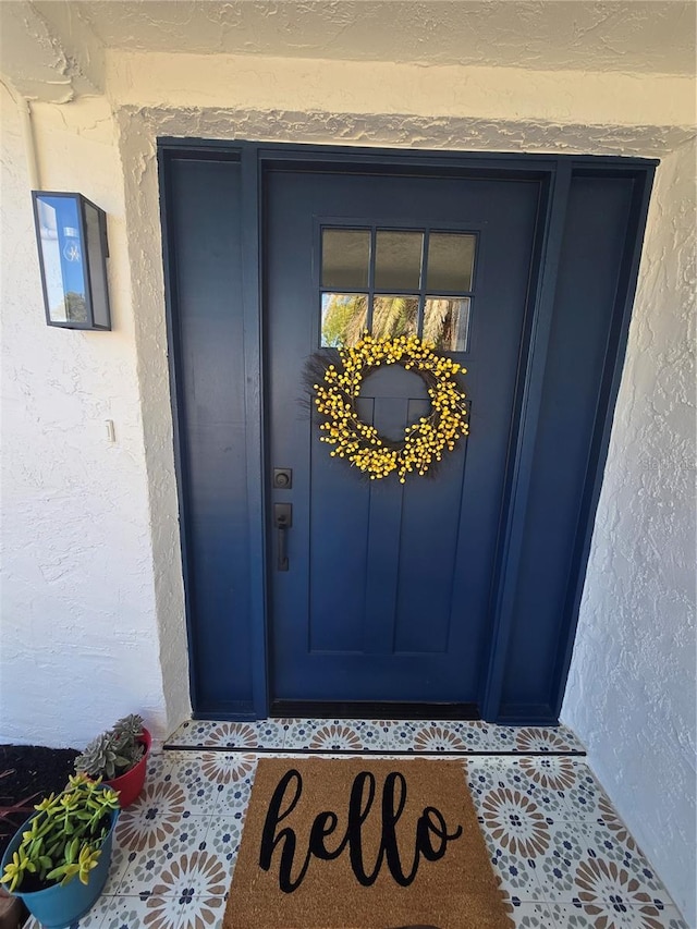 doorway to property with stucco siding