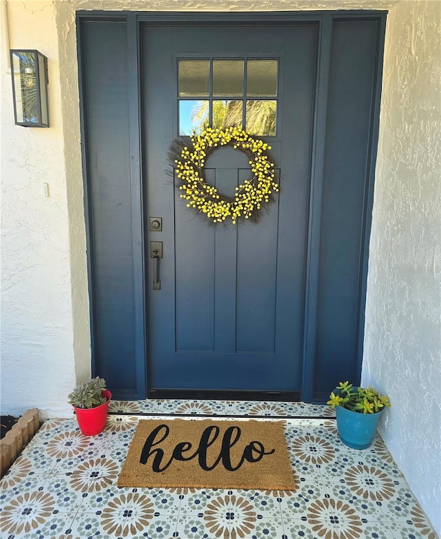 property entrance with stucco siding