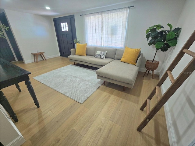 living room featuring recessed lighting, baseboards, and wood finished floors