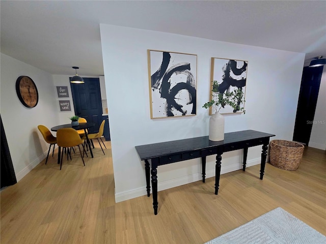 interior space featuring baseboards and light wood-type flooring