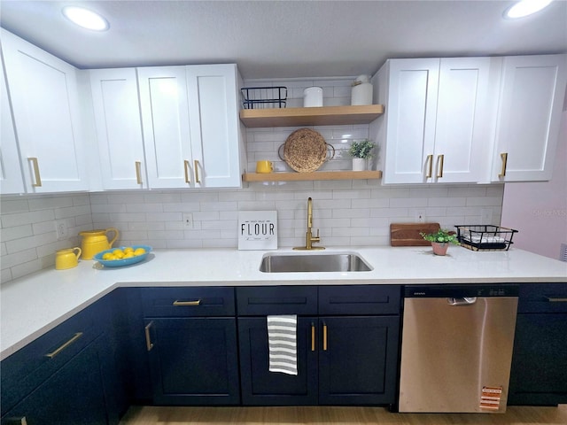 kitchen featuring open shelves, a sink, light countertops, white cabinets, and stainless steel dishwasher