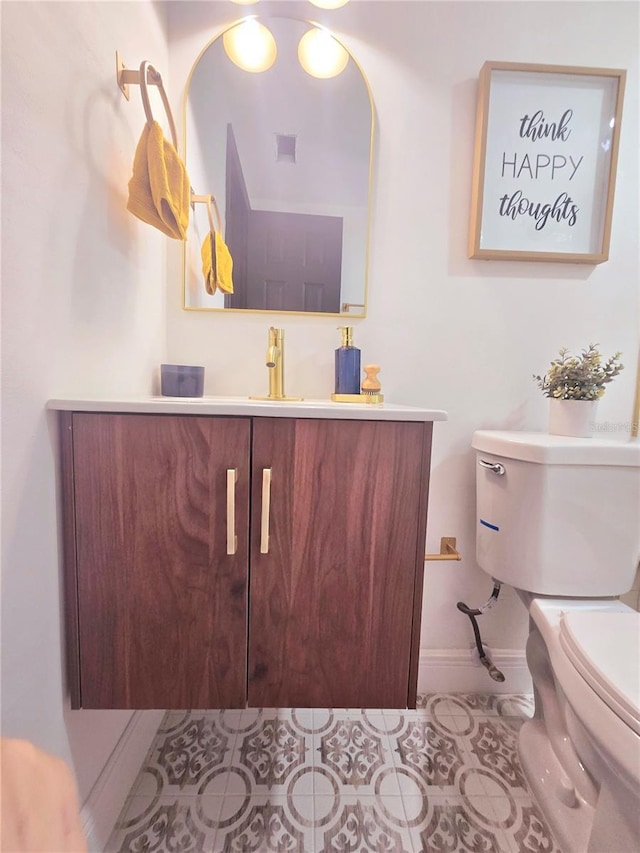 bathroom with visible vents, toilet, vanity, and tile patterned flooring