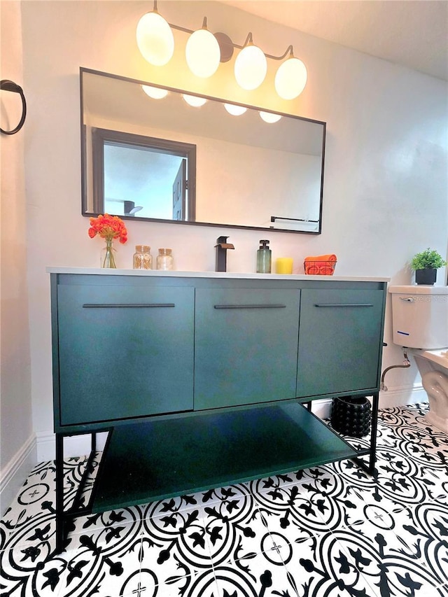 bathroom featuring tile patterned floors, baseboards, and vanity