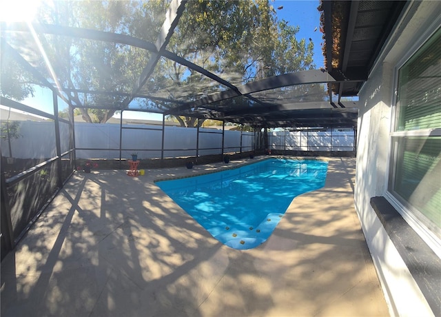 view of pool with a lanai, a patio area, a fenced in pool, and a fenced backyard