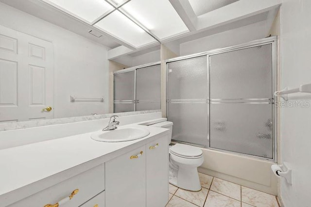 full bathroom featuring vanity, tile patterned floors, toilet, and shower / bath combination with glass door