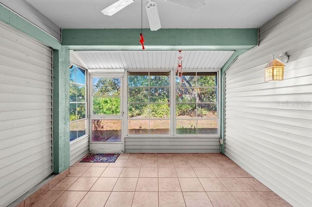 unfurnished sunroom with ceiling fan