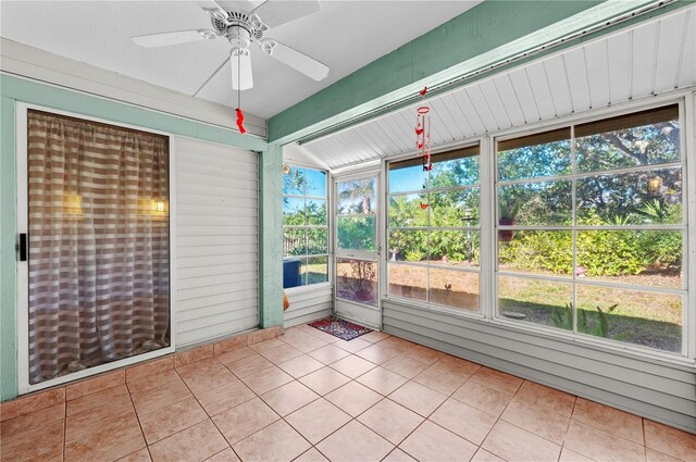 unfurnished sunroom with a ceiling fan