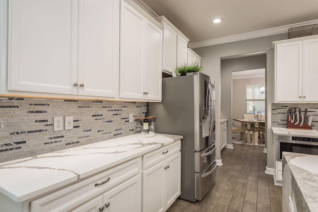 kitchen featuring decorative backsplash, white cabinets, and crown molding