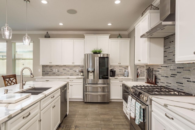 kitchen with white cabinetry, stainless steel appliances, wall chimney exhaust hood, and a sink