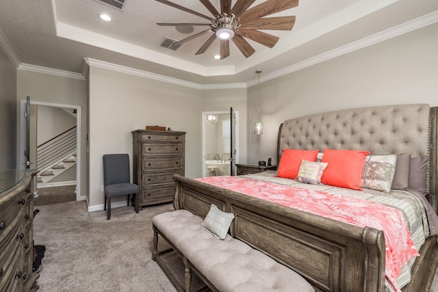 bedroom featuring light carpet, visible vents, a raised ceiling, and ornamental molding