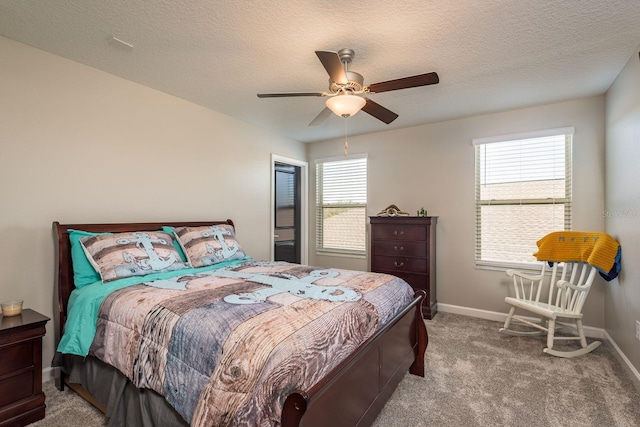 carpeted bedroom with baseboards, a textured ceiling, and ceiling fan