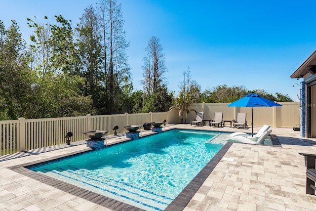 view of swimming pool with a fenced in pool, a patio, and fence