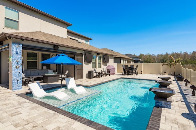 view of pool featuring outdoor dining area, a patio area, and a fenced backyard