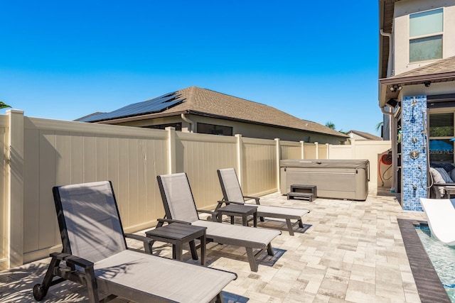 view of patio featuring a fenced backyard and a hot tub