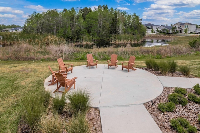 view of patio with a residential view and a water view