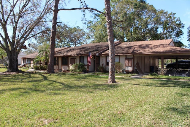 single story home featuring a carport and a front lawn